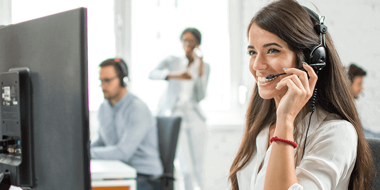 woman wearing headset using Microsoft Teams on computer