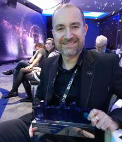 TSG CTO Paul Burns shows off the Breakthrough Partner of the Year award from Datto